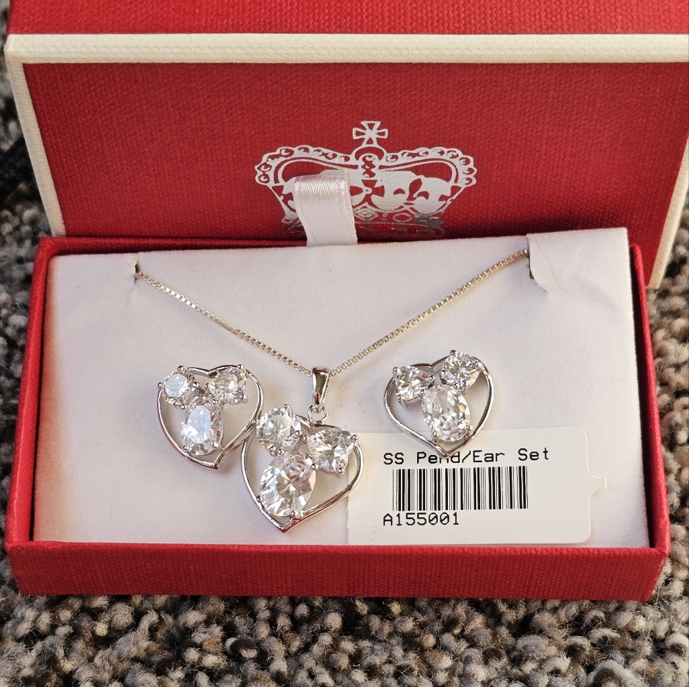 New in box. Sterling silver necklace set. Stamped 925. Heart design with sparkli